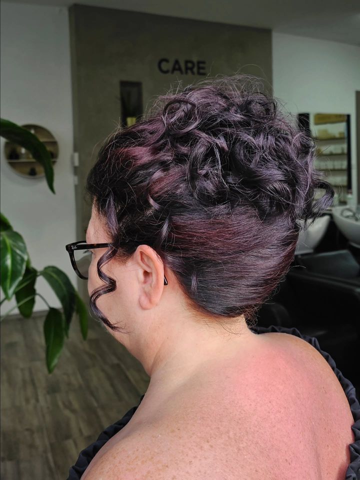 Chignon bouclé aux reflets prune
